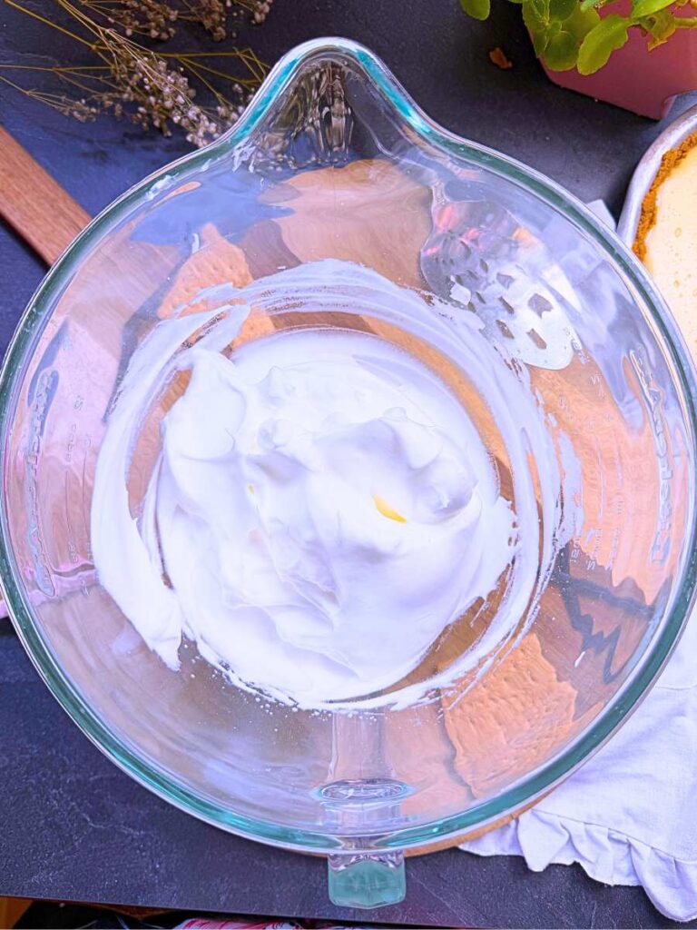 A glass bowl filled with meringue.