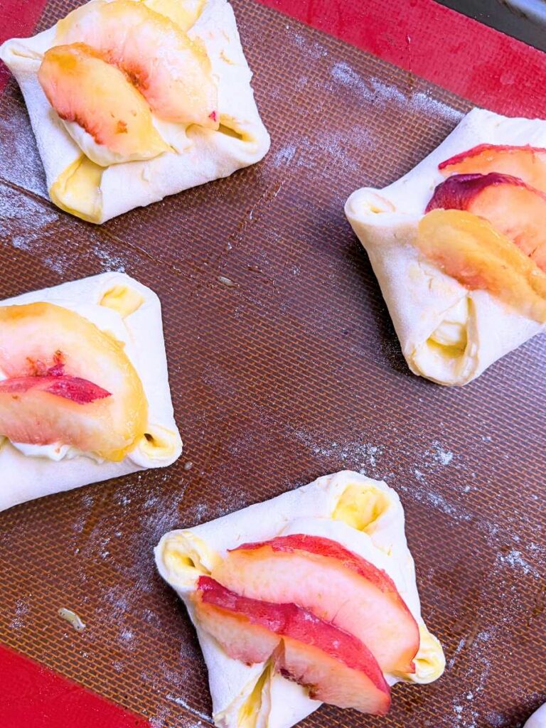 Danish dough with sliced peaches on top.
