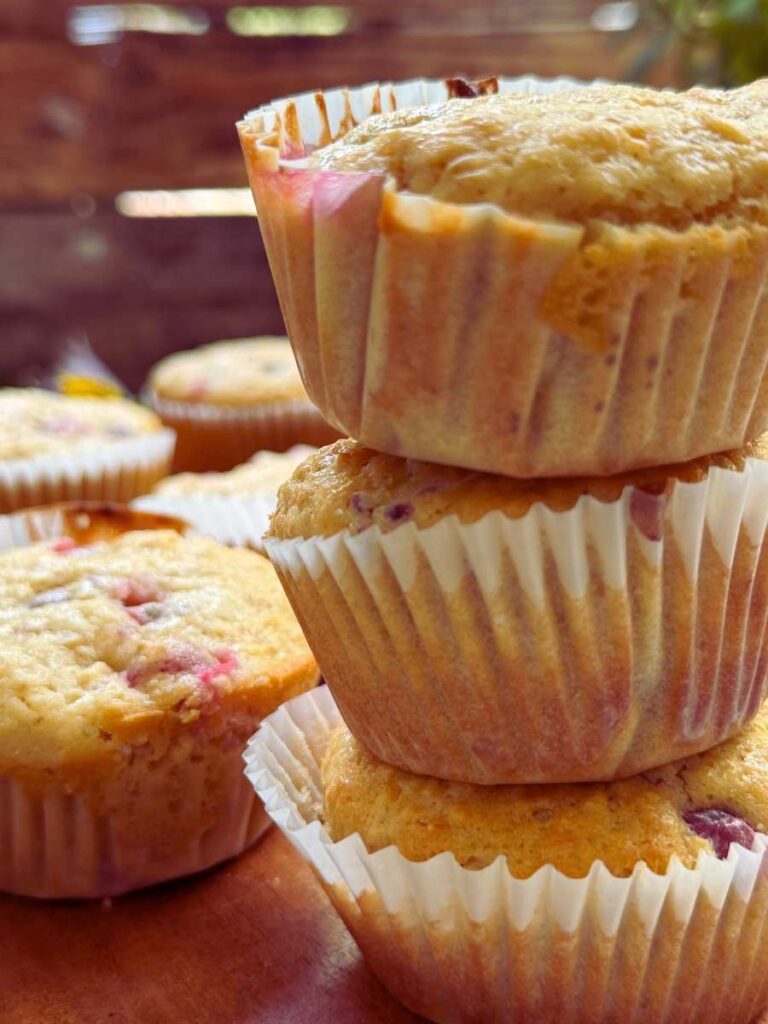 Three muffins stacked. There are more muffins behind.