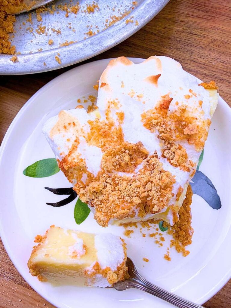 A slice of flapper pie with meringue on top. There is a forkful removed at the front.