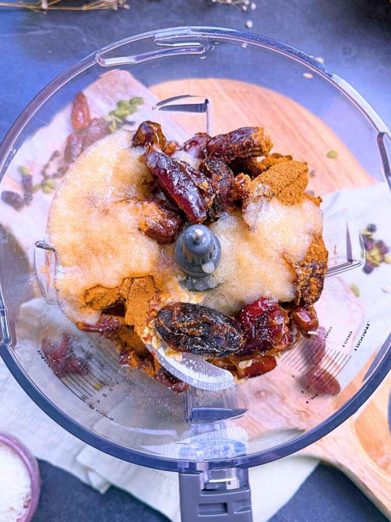 Dates, oats, and applesauce in a food processor.