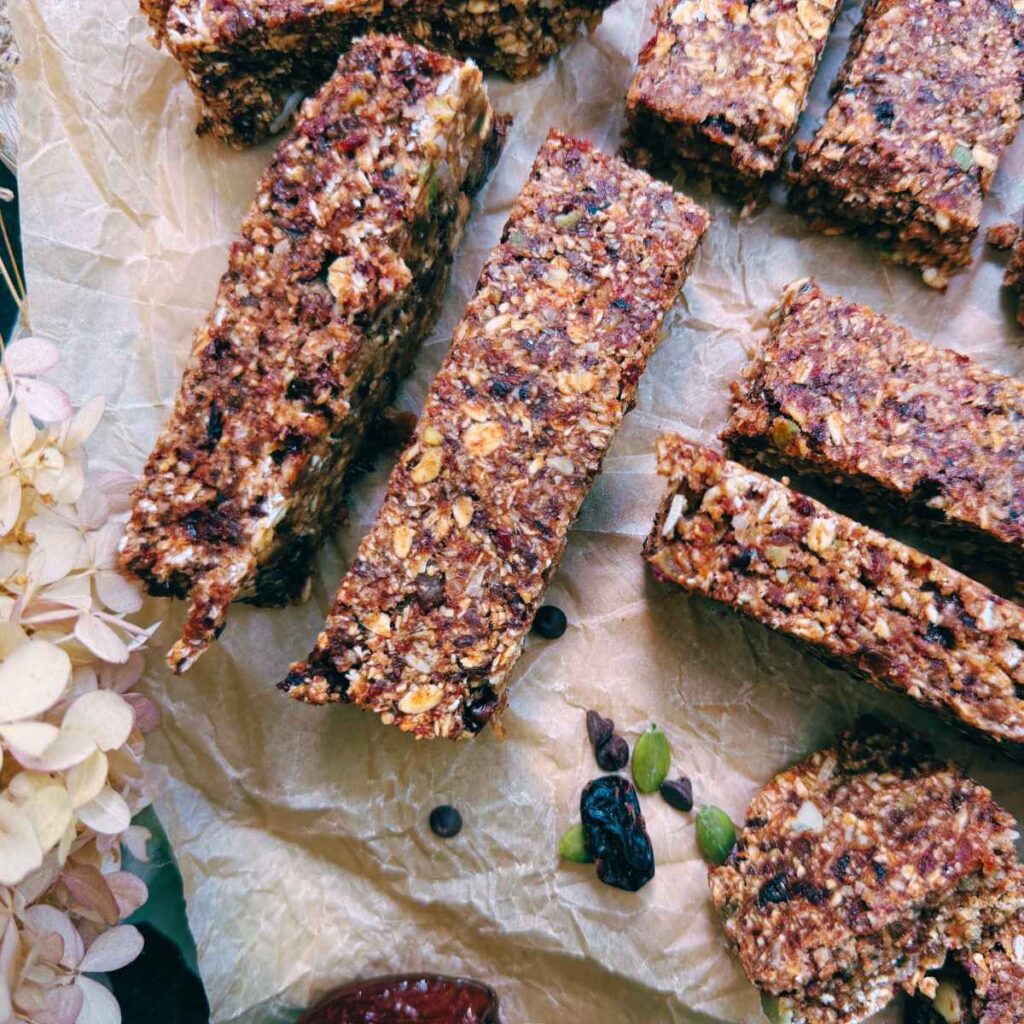 Sliced homemade granola bars on a piece of parchment paper.