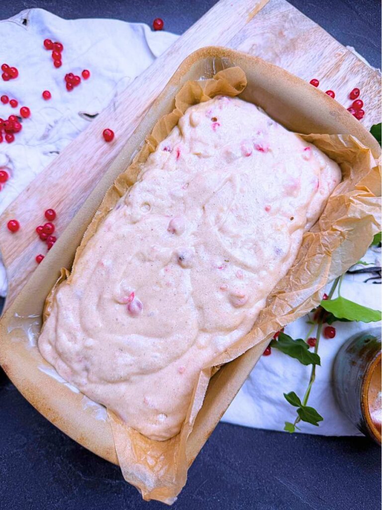 Red current cake batter in a stone loaf pan.