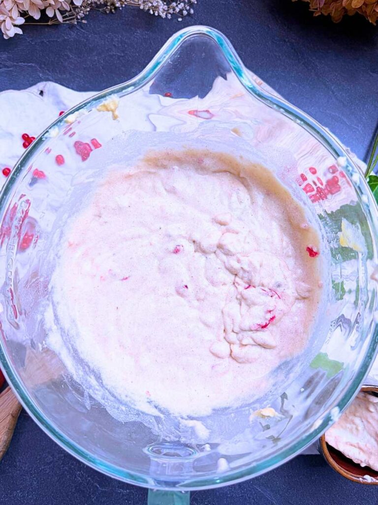 Red current cake batter with buttermilk, in a glass mixing bowl.