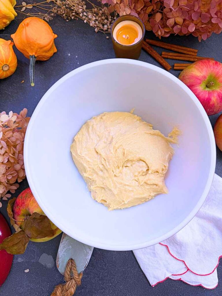 A white bowl with a brioche dough.