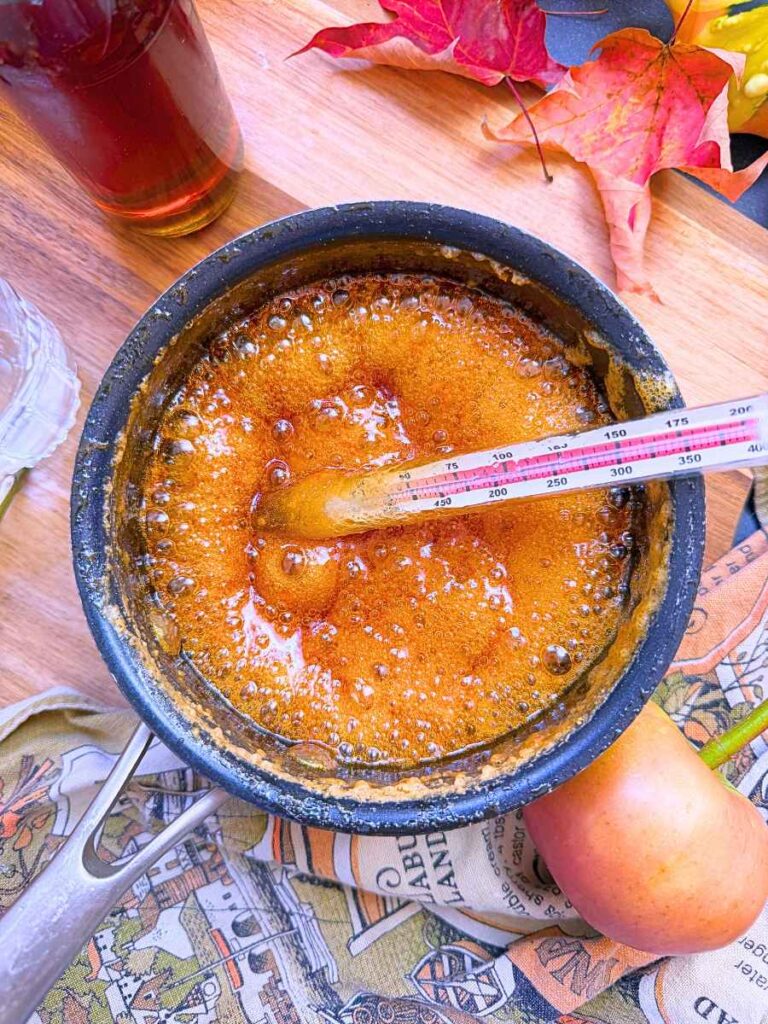 Boiling maple syrup in a black sauce pot.