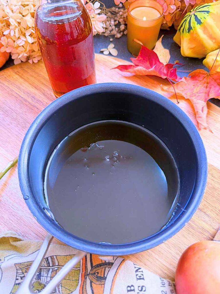 Maple syrup in a black sauce pot.
