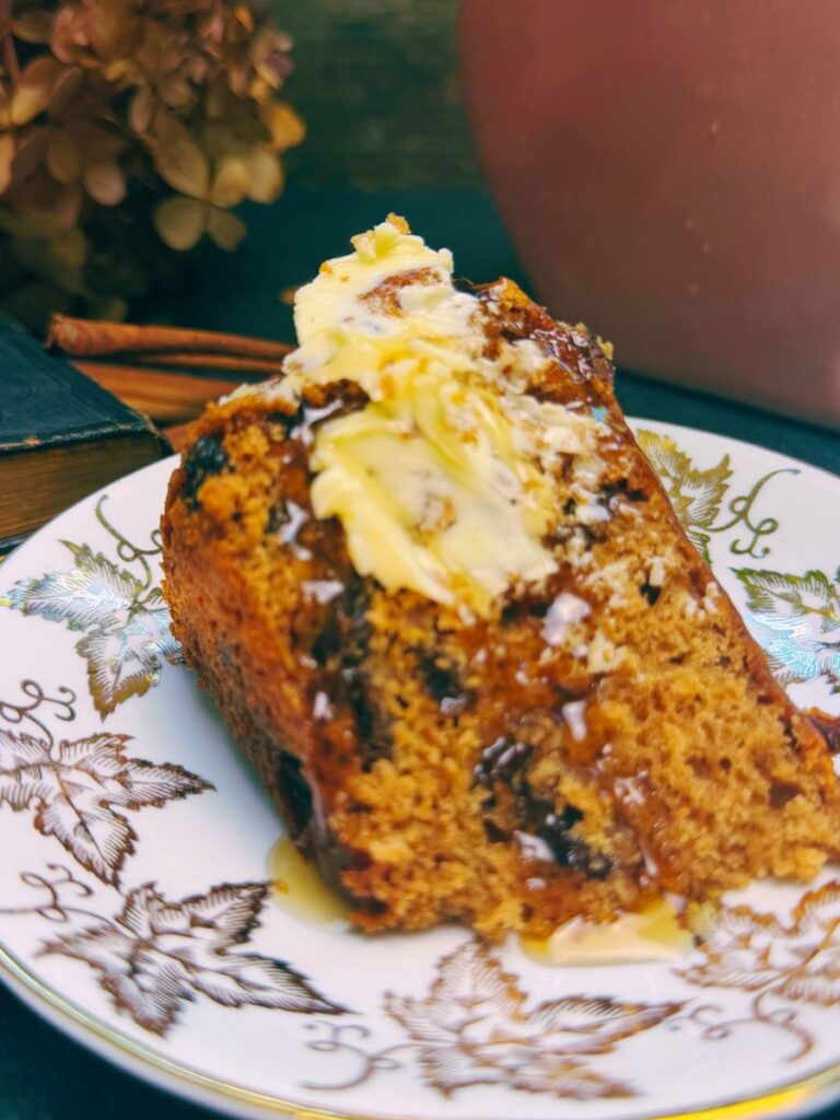 A slice of War cake with a bit of butter and syrup on top.