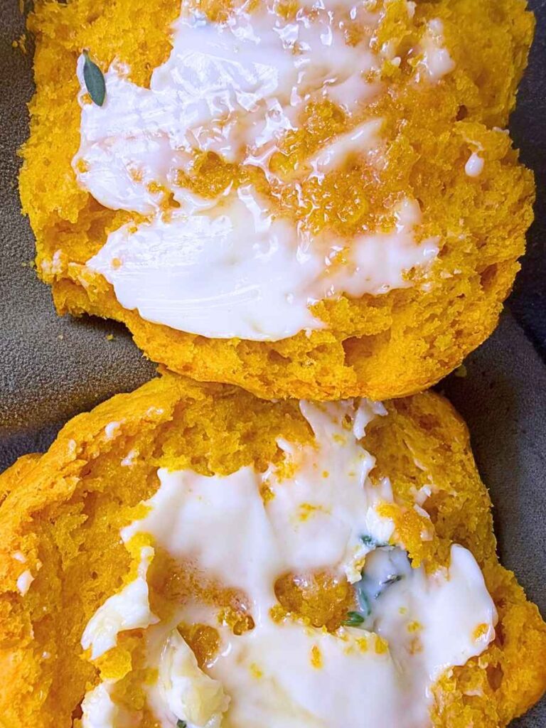 A close up look at buttered pumpkin biscuits.
