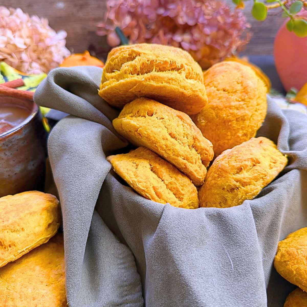 Pumpkin biscuits in a lined basket.