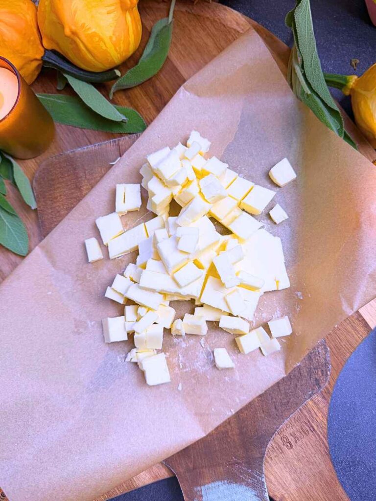 Cubed butter on a piece of parchment paper.