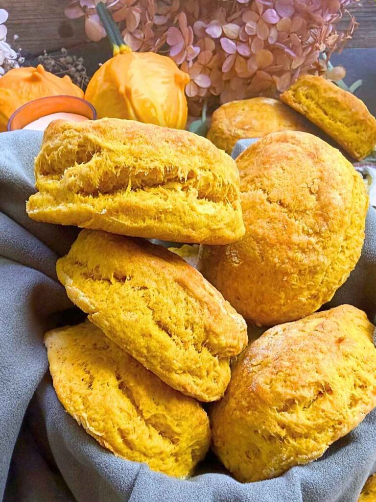 A side view of pumpkin biscuits in a linen lined basket.