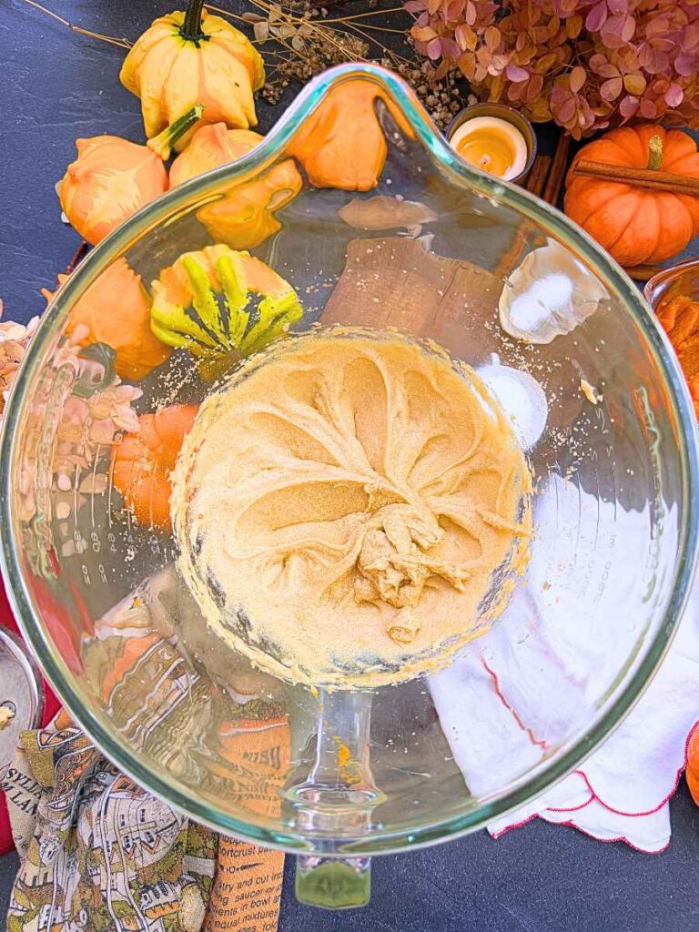 Creamed butter and sugar in a glass bowl.