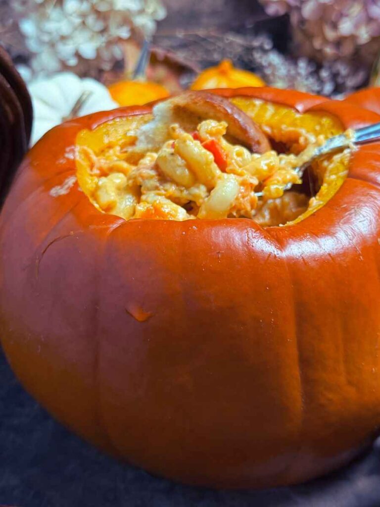 A cooked pumpkin with pumpkin pasta inside.
